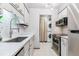 Modern kitchen featuring white cabinets, stainless steel appliances, and a laundry area at 7995 E Mississippi Ave # C11, Denver, CO 80247