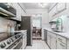 Bright, updated kitchen with stainless steel appliances, white cabinets, and access to the dining area at 7995 E Mississippi Ave # C11, Denver, CO 80247