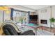 Inviting living room with brick fireplace, sliding glass doors, and comfortable seating arrangement at 7995 E Mississippi Ave # C11, Denver, CO 80247