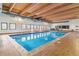Bright indoor pool area with a wood plank ceiling, brick floors, and multiple windows with views to the outside at 7995 E Mississippi Ave # C11, Denver, CO 80247