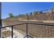 View of the backyard with retaining wall, metal fence and plants at 457 Interlocken Blvd # 101, Broomfield, CO 80021