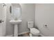 Half bathroom with pedestal sink, toilet and modern fixtures at 457 Interlocken Blvd # 101, Broomfield, CO 80021