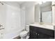 Full bathroom with tiled shower-tub, vanity with cabinet, and modern fixtures at 457 Interlocken Blvd # 101, Broomfield, CO 80021