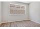 Empty bedroom featuring modern wood flooring and large window at 457 Interlocken Blvd # 101, Broomfield, CO 80021