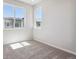 Bright bedroom features neutral carpet, white walls and two large windows at 457 Interlocken Blvd # 101, Broomfield, CO 80021
