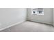 Bright bedroom with plush carpeting, neutral walls, and a large window at 457 Interlocken Blvd # 101, Broomfield, CO 80021