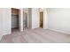 Bedroom featuring neutral carpet, closet, and multiple doorways at 457 Interlocken Blvd # 101, Broomfield, CO 80021