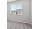 Bright bedroom features neutral carpet, white walls and a large window at 457 Interlocken Blvd # 101, Broomfield, CO 80021