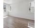 Bright empty bedroom featuring modern wood flooring and two windows at 457 Interlocken Blvd # 101, Broomfield, CO 80021