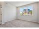Bright bedroom features neutral carpet, white walls and a large picture window at 457 Interlocken Blvd # 101, Broomfield, CO 80021