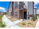 Attractive two-story townhome with a brick facade and a small balcony at 457 Interlocken Blvd # 101, Broomfield, CO 80021