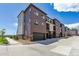 Townhome exterior with a garage and modern design elements at 457 Interlocken Blvd # 101, Broomfield, CO 80021