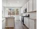 Modern kitchen with white cabinets, stainless steel appliances, and island at 457 Interlocken Blvd # 101, Broomfield, CO 80021
