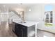 Kitchen island with double sink, modern faucet, and stainless steel dishwasher, adjacent to outdoor access at 457 Interlocken Blvd # 101, Broomfield, CO 80021