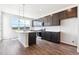 A modern kitchen with dark cabinets, stainless steel appliances and a white countertop island at 457 Interlocken Blvd # 101, Broomfield, CO 80021