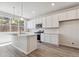 Modern kitchen with white cabinetry, island, and stainless steel appliances at 457 Interlocken Blvd # 101, Broomfield, CO 80021