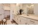 Elegant bathroom with double sinks, modern fixtures, and walk-in closet at 3461 N Buchanan Way, Aurora, CO 80019