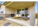 Inviting covered patio with comfortable seating, a grill, and sliding glass doors for seamless indoor-outdoor living at 3461 N Buchanan Way, Aurora, CO 80019