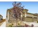Exterior of home showcasing well-manicured landscaping, stone facade, and tan siding at 3461 N Buchanan Way, Aurora, CO 80019