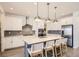Well-lit kitchen featuring stainless steel appliances, white cabinets, and an island with bar seating at 3461 N Buchanan Way, Aurora, CO 80019