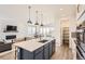 Modern kitchen featuring a large island, stainless steel appliances, and an open layout at 3461 N Buchanan Way, Aurora, CO 80019