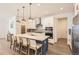 Modern kitchen with stainless steel appliances, island with bar seating, and hardwood floors at 3461 N Buchanan Way, Aurora, CO 80019