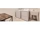 Functional laundry room equipped with a washer, dryer, utility sink, and neutral tile flooring at 3461 N Buchanan Way, Aurora, CO 80019