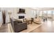 Open concept living room with hardwood floors, fireplace, and ample natural light at 3461 N Buchanan Way, Aurora, CO 80019
