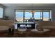 Contemporary living room with stylish furniture, large sliding doors, a modern chandelier, and bright natural light at 3461 N Buchanan Way, Aurora, CO 80019