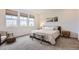 Comfortable main bedroom with three large windows and a cozy, light, modern decor at 3461 N Buchanan Way, Aurora, CO 80019