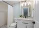 Updated bathroom with shower, decorative mirror and sleek vanity with modern fixtures at 7257 S Millbrook Ct, Aurora, CO 80016
