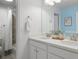 Bathroom with double vanity, brushed nickel fixtures, white cabinets, and shower with curtain at 7257 S Millbrook Ct, Aurora, CO 80016