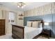 Cozy bedroom with natural light, decorative wallpaper, dark wood trim, and neutral decor at 7257 S Millbrook Ct, Aurora, CO 80016