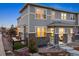Charming gray townhome featuring stone accents, a cozy front porch, and a fenced-in side yard at 7257 S Millbrook Ct, Aurora, CO 80016