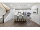 Modern kitchen with stainless steel appliances, white cabinetry and a spacious island with seating at 7257 S Millbrook Ct, Aurora, CO 80016