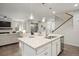 Bright, open-concept kitchen features a large island with granite countertops and modern pendant lighting at 7257 S Millbrook Ct, Aurora, CO 80016