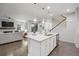 Bright, open-concept kitchen features a large island with granite countertops and modern pendant lighting at 7257 S Millbrook Ct, Aurora, CO 80016