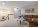Cozy living room with carpet, comfortable seating, and lots of natural light from the windows at 7257 S Millbrook Ct, Aurora, CO 80016