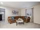Comfortable living room featuring plush seating, a round coffee table, and natural light from a window at 7257 S Millbrook Ct, Aurora, CO 80016