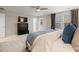 Bright main bedroom featuring comfortable bed, TV, large windows, and neutral decor at 7257 S Millbrook Ct, Aurora, CO 80016