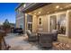 Cozy covered patio with comfortable seating, string lights, privacy fence, and sliding glass doors at 7257 S Millbrook Ct, Aurora, CO 80016