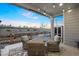 Charming outdoor patio with comfortable seating area, rock garden, and string lights at 7257 S Millbrook Ct, Aurora, CO 80016