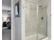 Modern bathroom featuring tile shower, glass door and neutral color scheme at 7257 S Millbrook Ct, Aurora, CO 80016