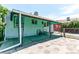 View of the side and back of a quaint home featuring a small patio and fenced yard at 745 S Utica St, Denver, CO 80219