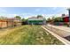 Fenced-in backyard featuring a well-maintained lawn and a view of the home's exterior at 745 S Utica St, Denver, CO 80219