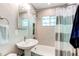 Bright bathroom with neutral tile, classic fixtures, and a shower-tub combination at 745 S Utica St, Denver, CO 80219
