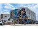 Apartment Building mural of Personal on side with street level traffic in front at 745 S Utica St, Denver, CO 80219