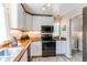 Functional kitchen featuring butcher block countertops and stainless steel appliances at 745 S Utica St, Denver, CO 80219