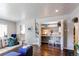 Open-concept living area with hardwood floors and built-in shelving perfect for a home office space at 745 S Utica St, Denver, CO 80219
