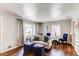 Bright living room featuring hardwood floors, neutral walls, and stylish, comfortable furnishings at 745 S Utica St, Denver, CO 80219